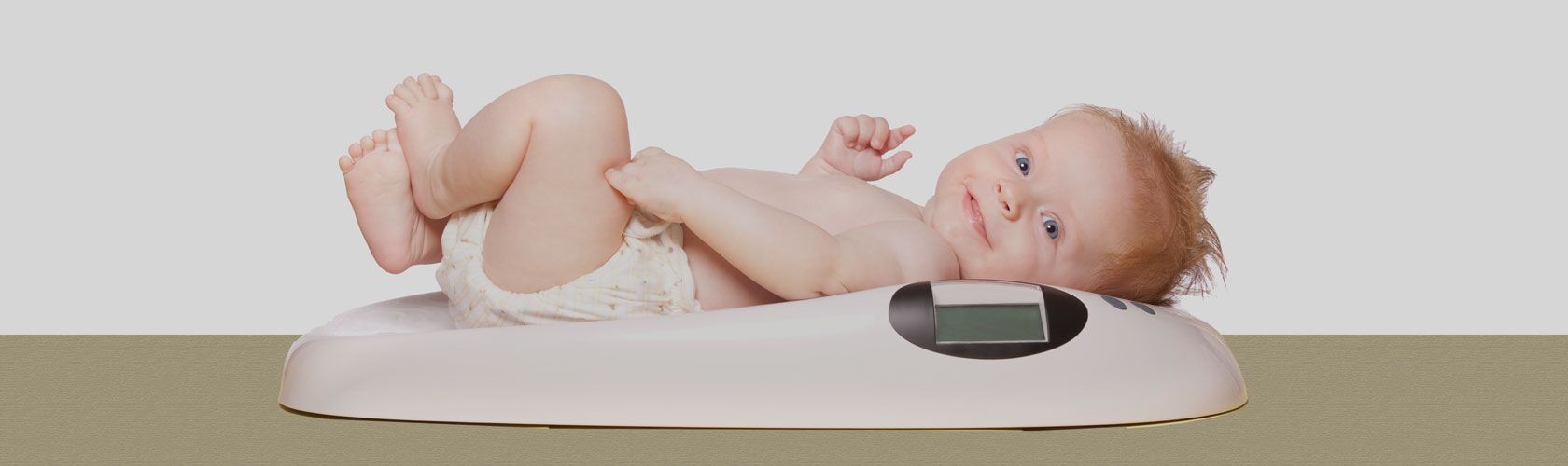 Service Verleih Babywaage Beilharz Apotheke Isny Ein Baby liegt entspannt auf einer digitalen Waage, um in der Beilharz Apotheke in Isny gewogen zu werden.